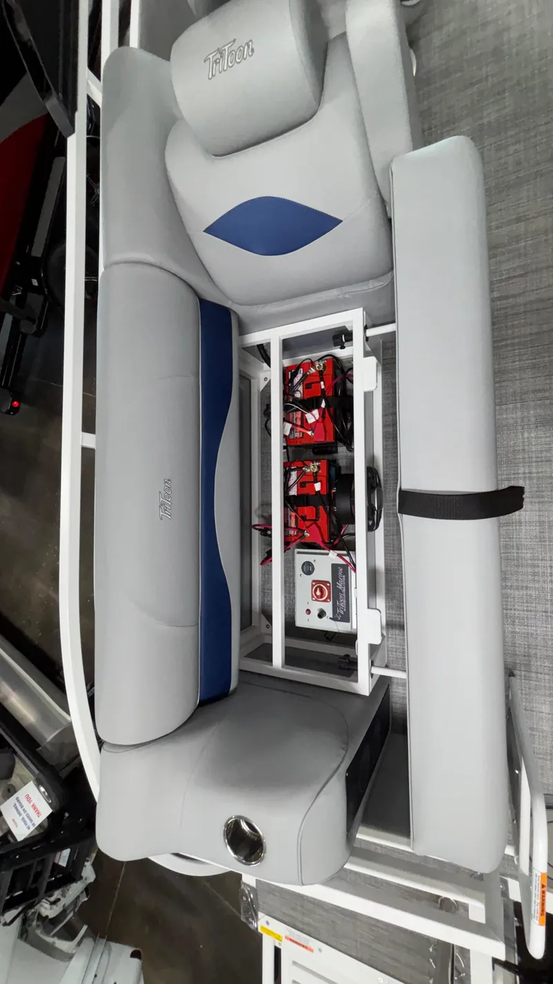 Slide: The Image of 2025 JC Neptoon 25TT Sport boat interior with gray seating and visible battery compartment. - 10