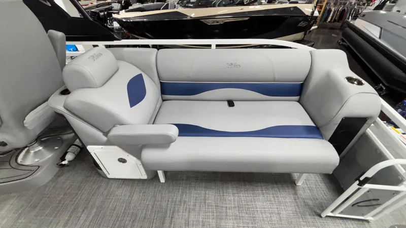 Slide: The Image of Luxury seating on 2025 JC Neptoon 25TT Sport pontoon boat, featuring gray and blue upholstery. - 11