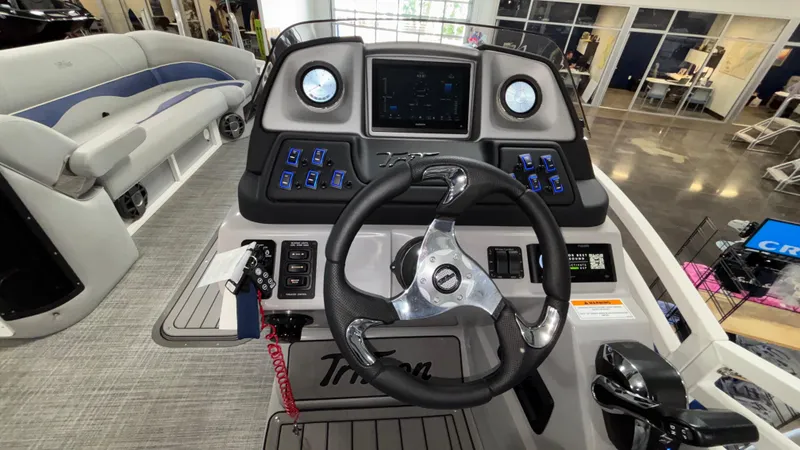 Slide: The Image of 2025 JC Neptoon 25TT Sport boat dashboard with steering wheel and control panel. - 12
