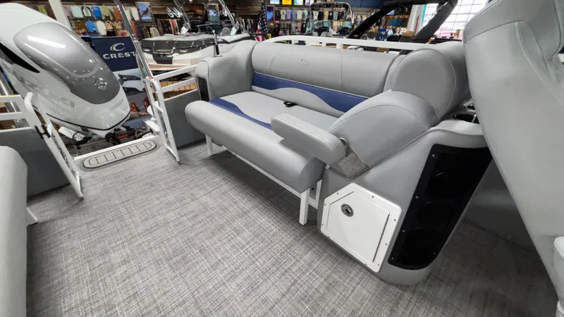 Slide: The Image of 2025 JC Neptoon 25TT Sport pontoon boat interior with gray seating and modern design. - 16