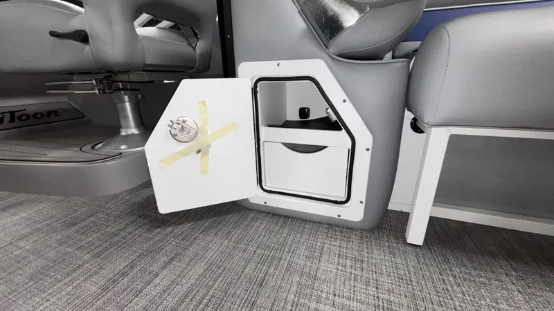Slide: The Image of Interior storage compartment of 2025 JC Neptoon 25TT Sport boat, featuring sleek design. - 22