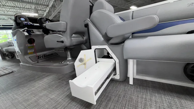 Slide: The Image of 2025 JC Neptoon 25TT Sport boat interior with gray seating and storage compartment. - 23