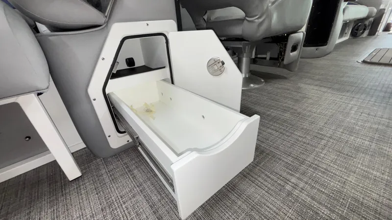 Slide: The Image of Open storage compartment in 2025 JC Neptoon 25TT Sport boat interior. - 25