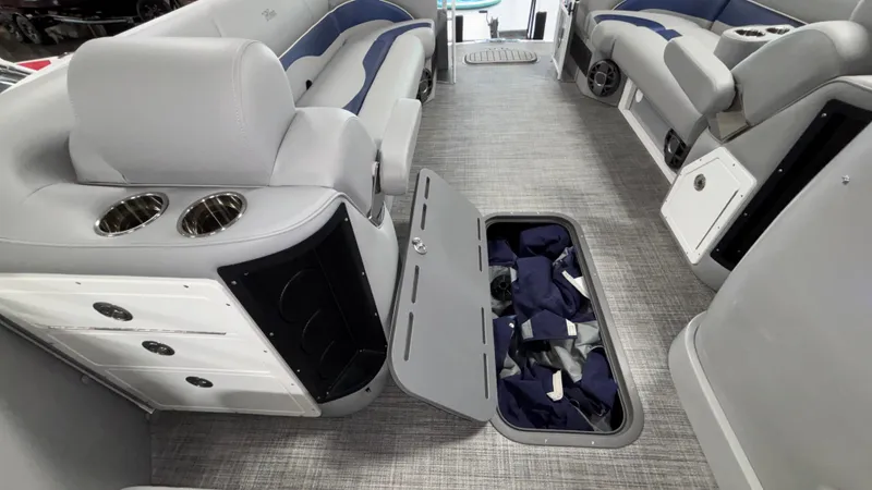 Slide: The Image of 2025 JC Neptoon 25TT Sport interior with open storage compartment and plush seating. - 31