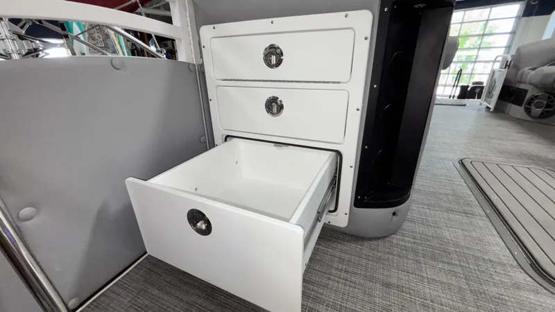 Slide: The Image of Open storage drawers on 2025 JC Neptoon 25TT Sport boat interior. - 35