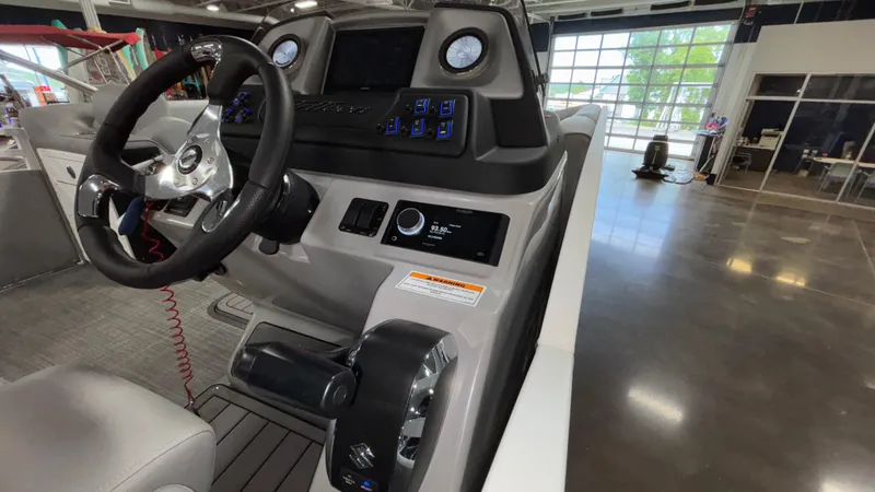 Slide: The Image of 2025 JC Neptoon 25TT Sport boat dashboard with steering wheel and control panel. - 37