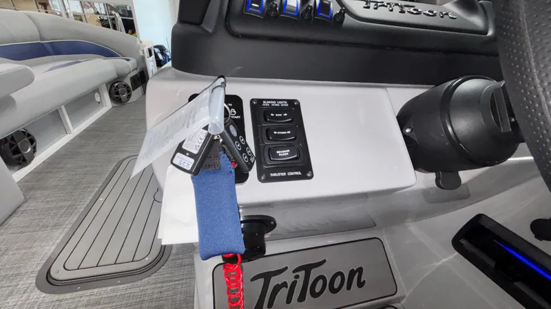 Slide: The Image of Control panel of 2025 JC Neptoon 25TT Sport boat with steering wheel and switches. - 39
