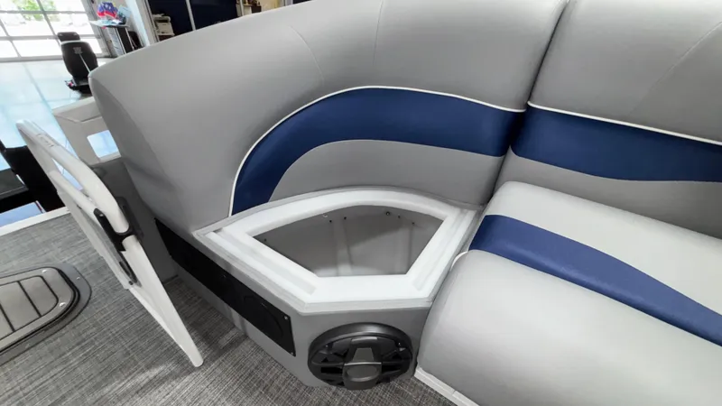 Slide: The Image of 2025 JC Neptoon 25TT Sport boat interior with gray and blue seating and built-in storage. - 46