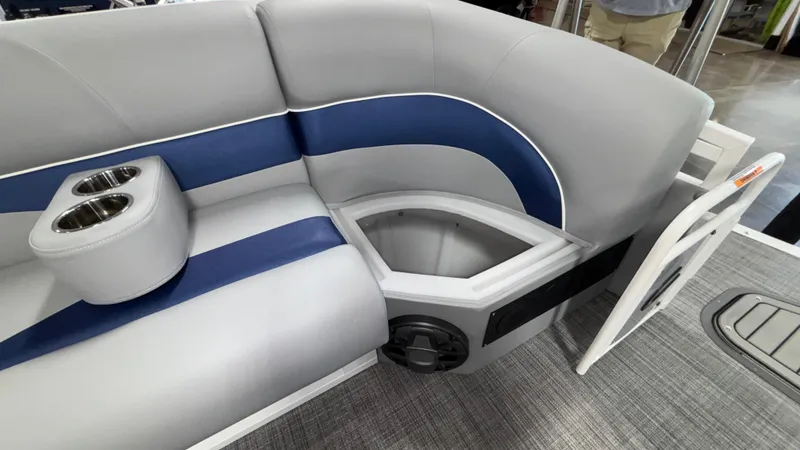 Slide: The Image of 2025 JC Neptoon 25TT Sport boat interior with gray and blue seating, cup holders, and storage compartment. - 47