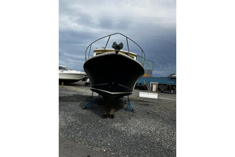 Slide: The Image of 2016 Eastern 27 Islander boat on stands, cloudy sky background. - 33