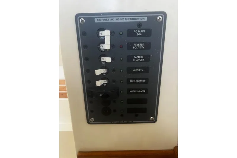 Slide: The Image of Electrical panel on a 2016 Eastern 27 Islander boat, featuring various circuit breakers. - 41