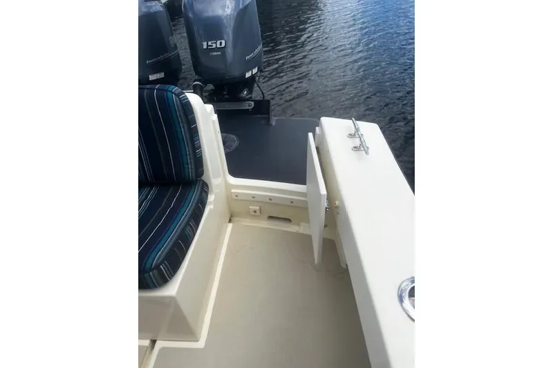 Slide: The Image of 2016 Eastern 27 Islander boat interior with striped seating and dual outboard motors. - 12