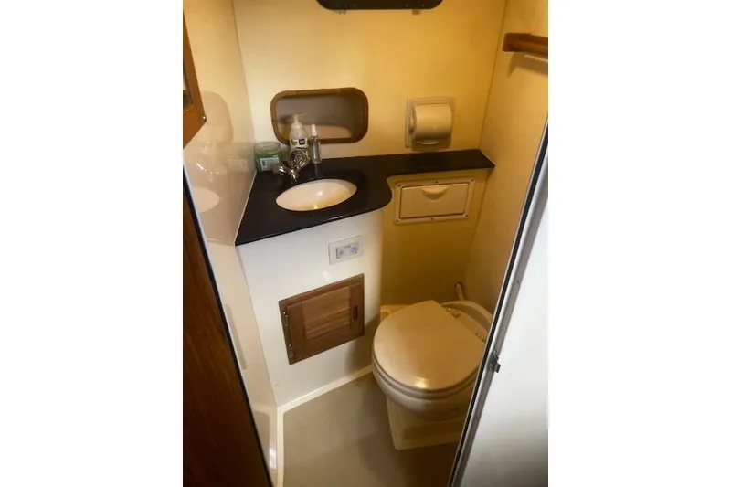 Slide: The Image of Compact bathroom in 2016 Eastern 27 Islander boat with sink and toilet. - 28