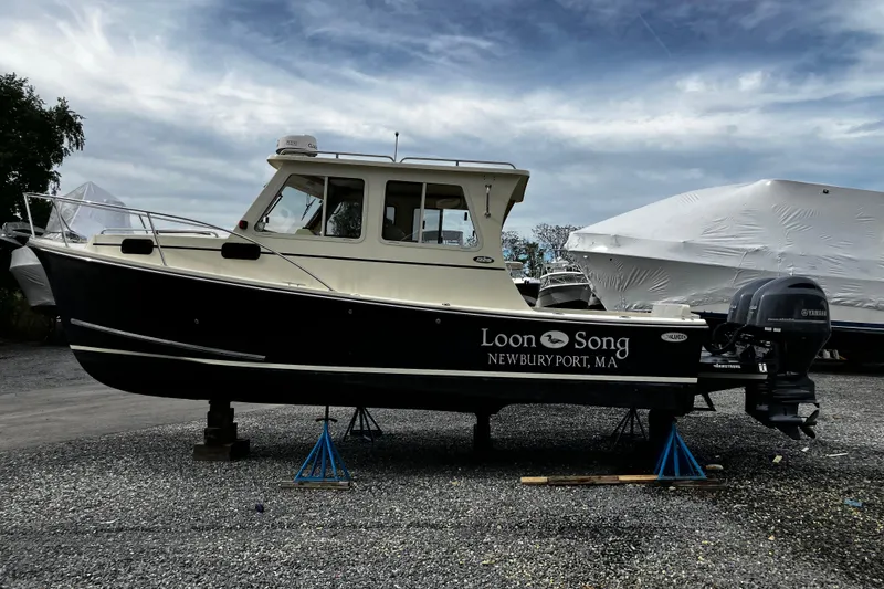 Slide: The Image of 2016 Eastern 27 Islander boat "Loon Song" on stands, Newburyport, MA, under cloudy sky. - 31