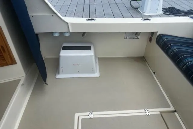 Slide: The Image of 2016 Eastern 27 Islander boat interior with seating and storage compartments. - 13