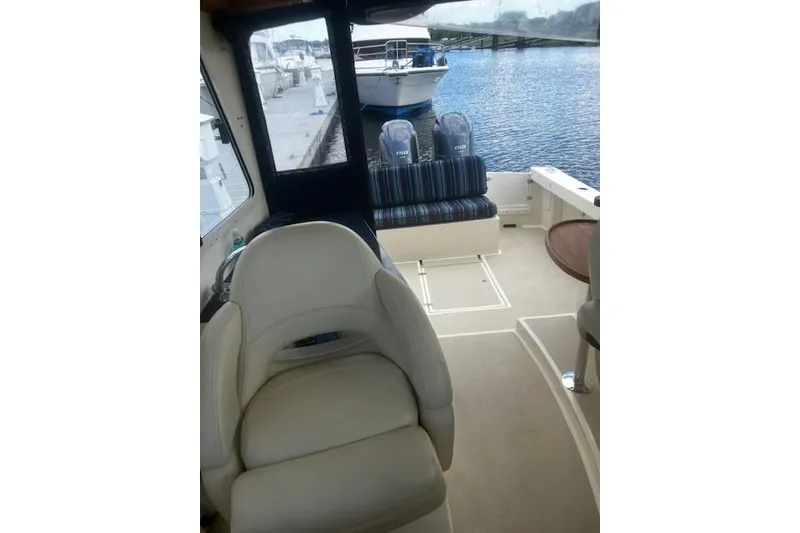 Slide: The Image of Interior view of 2016 Eastern 27 Islander boat with seating and water backdrop. - 23