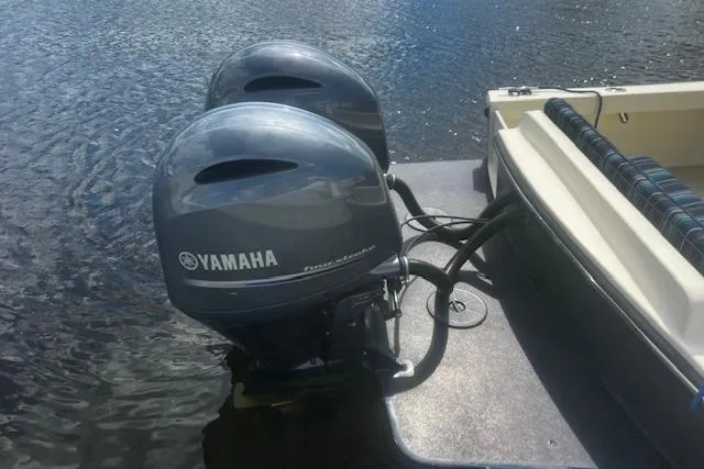 Slide: The Image of Twin Yamaha outboard motors on a 2016 Eastern 27 Islander boat in water. - 8