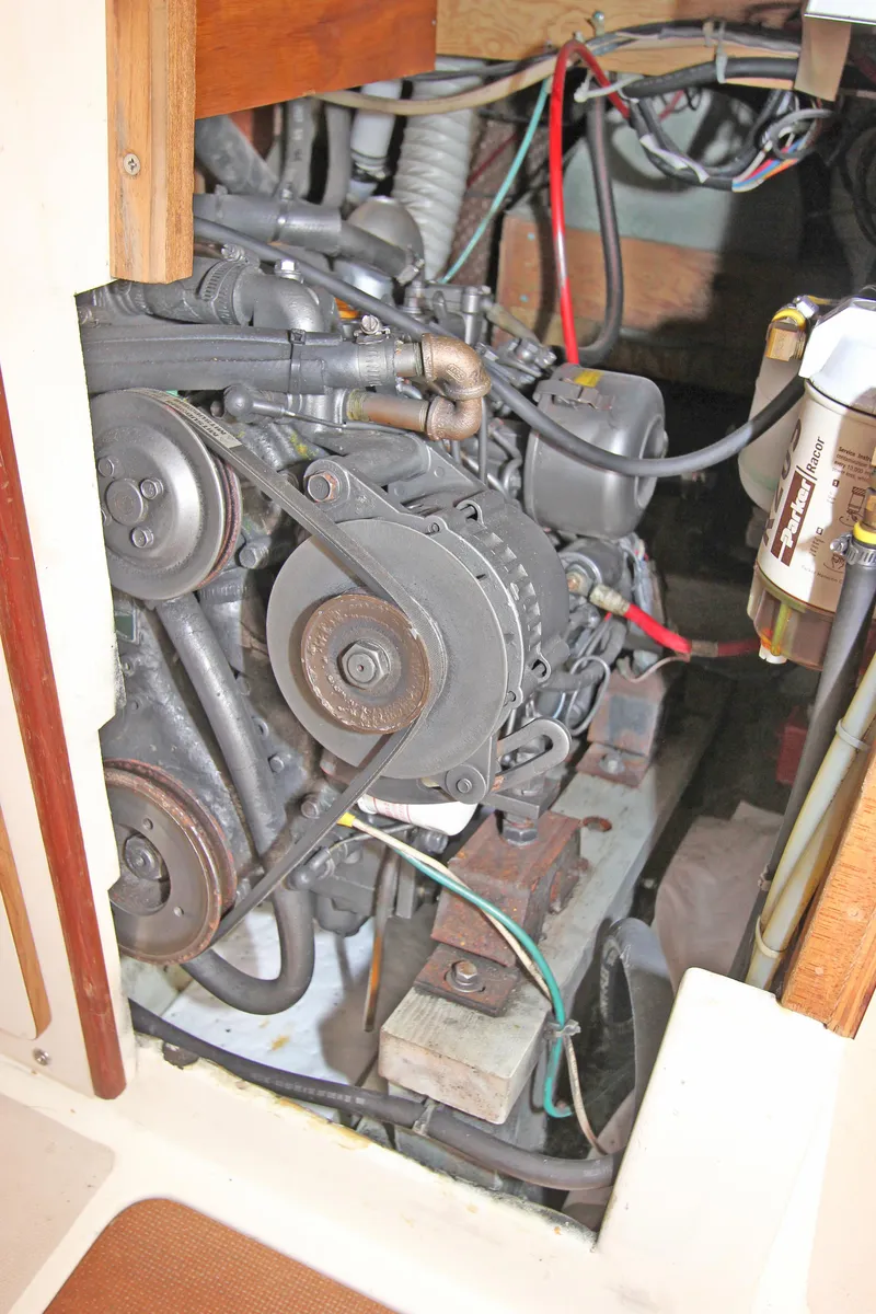 Slide: The Image of Engine compartment of a 1977 Pearson 10M sailboat, showing mechanical components and wiring. - 12