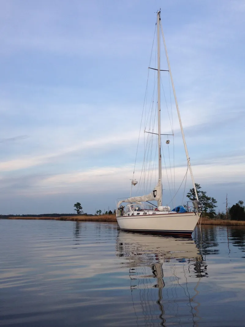Slide: The Image of 1987 Tartan 40CB sailboat on calm water under a clear sky. - 1