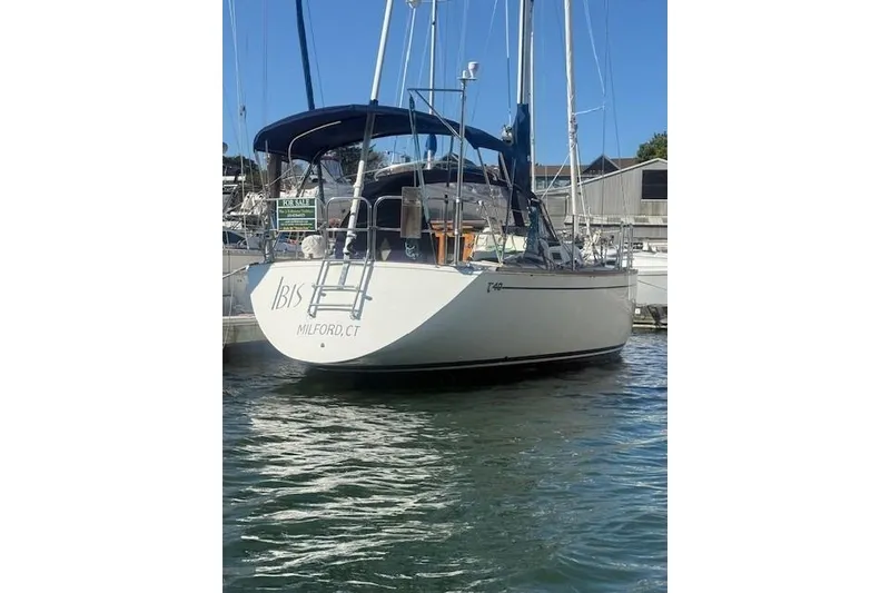 Slide: The Image of 1987 Tartan 40CB sailboat docked in Milford, CT, with "For Sale" sign. - 111