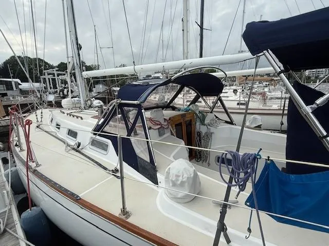 Slide: The Image of 1987 Tartan 40CB sailboat docked, featuring a sleek design and spacious deck. - 14