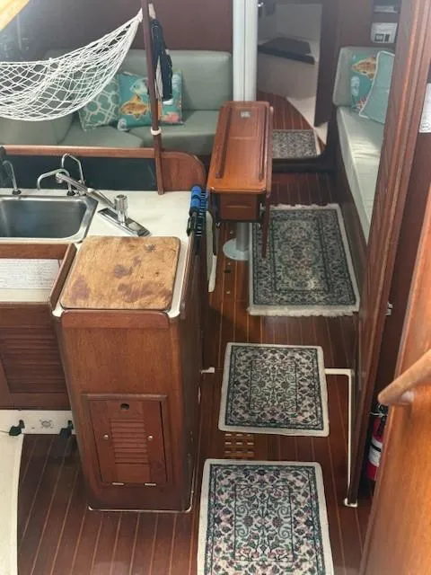 Slide: The Image of Interior of 1987 Tartan 40CB sailboat with wood finish and patterned rugs. - 18