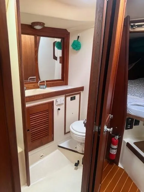 Slide: The Image of 1987 Tartan 40CB yacht bathroom with wooden cabinetry and compact design. - 23