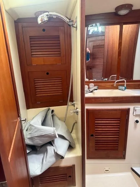 Slide: The Image of 1987 Tartan 40CB yacht bathroom with wooden cabinets and shower. - 24