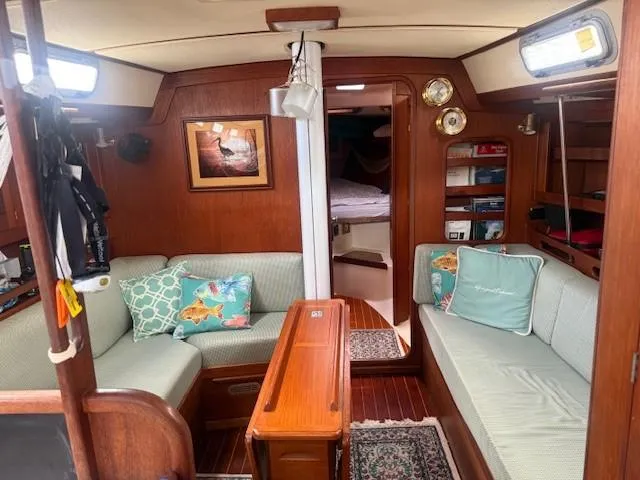 Slide: The Image of Cozy interior of a 1987 Tartan 40CB sailboat with wooden furnishings and cushioned seating. - 29