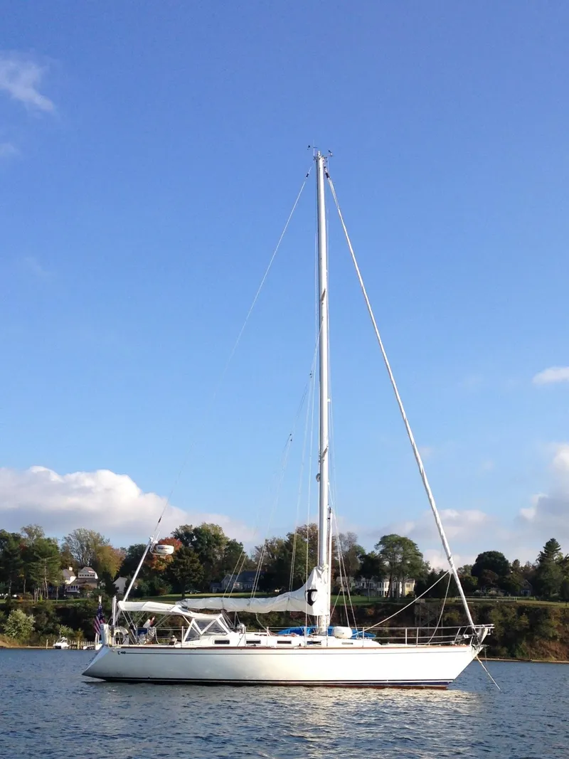 Slide: The Image of 1987 Tartan 40CB sailboat on calm water under clear blue sky. - 3