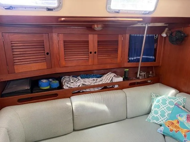 Slide: The Image of Cozy interior of 1987 Tartan 40CB sailboat with wooden cabinets and cushioned seating. - 30
