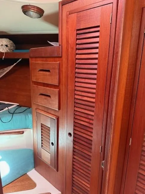 Slide: The Image of 1987 Tartan 40CB interior with wooden cabinetry and blue seating. - 34