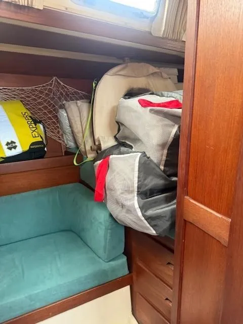 Slide: The Image of Cozy cabin interior of 1987 Tartan 40CB sailboat with storage and seating. - 36