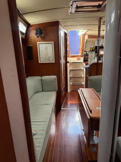 Slide: The Image of 1987 Tartan 40CB yacht interior with wood finish and cozy seating area. - 39