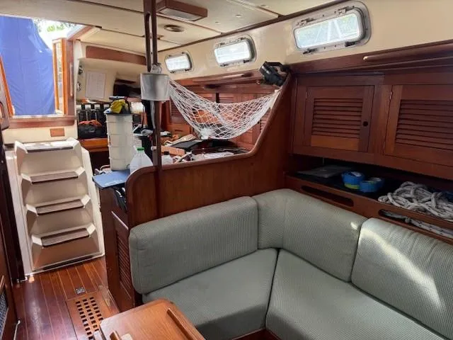 Slide: The Image of Interior of a 1987 Tartan 40CB sailboat with cozy seating and wooden cabinetry. - 41