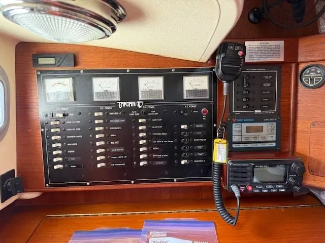 Slide: The Image of Electrical control panel on a 1987 Tartan 40CB sailboat, featuring gauges and communication devices. - 43
