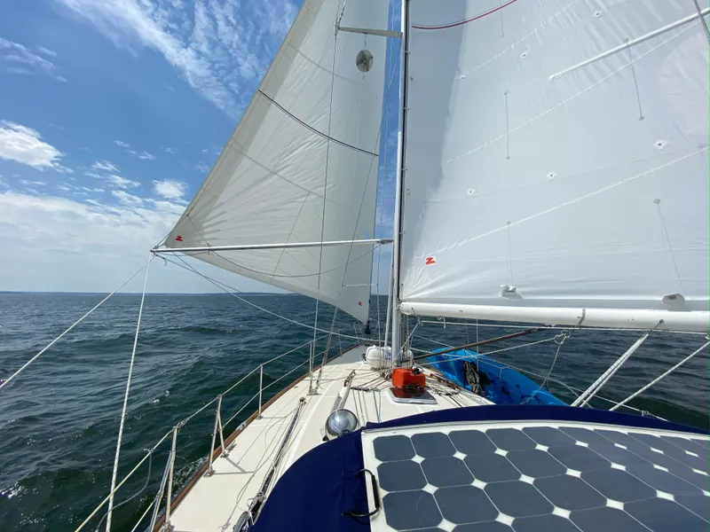 Slide: The Image of Sailing on a 1987 Tartan 40CB yacht with white sails under a clear blue sky. - 5