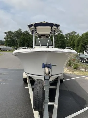 Slide: The Image of 2006 Sea Hunt Triton boat on trailer in parking lot, surrounded by trees. - 11