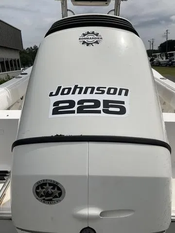 Slide: The Image of 2006 Sea Hunt Triton boat with Johnson 225 engine, Bombardier logo visible. - 3