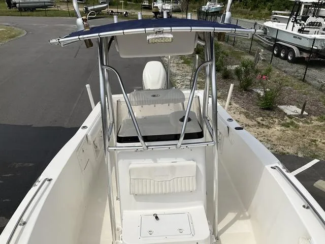 Slide: The Image of 2006 Sea Hunt Triton boat with T-top, viewed from above, parked on a paved area. - 6