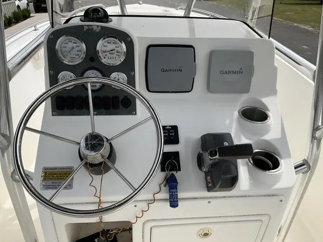 Slide: The Image of 2006 Sea Hunt Triton boat dashboard with Garmin navigation and steering wheel. - 8