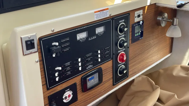 Slide: The Image of Control panel of 2022 Ranger Tugs R-25 boat with switches and gauges. - 23