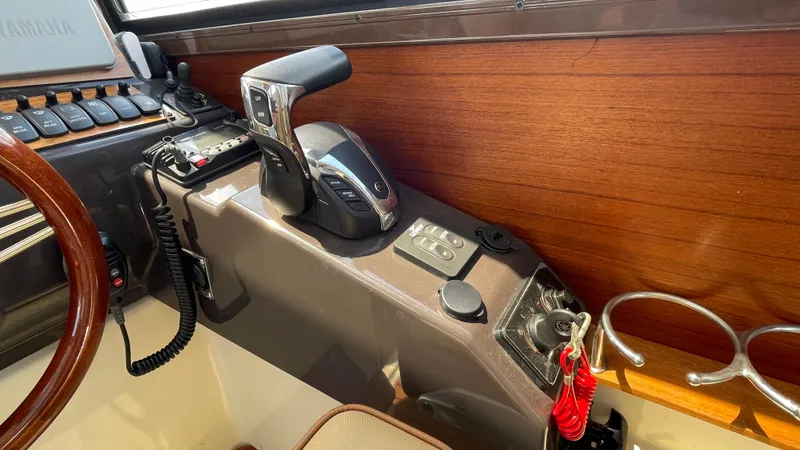 Slide: The Image of Control panel of 2022 Ranger Tugs R-25 boat with throttle and switches. - 24