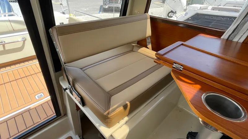 Slide: The Image of Interior seating of 2022 Ranger Tugs R-25 boat with foldable table and cup holder. - 27