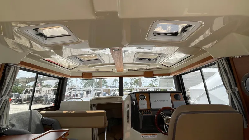 Slide: The Image of Interior of 2022 Ranger Tugs R-25 boat with modern helm and seating area. - 35