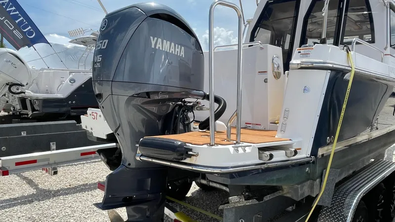 Slide: The Image of 2022 Ranger Tugs R-25 with Yamaha outboard motor, docked on a trailer. - 6