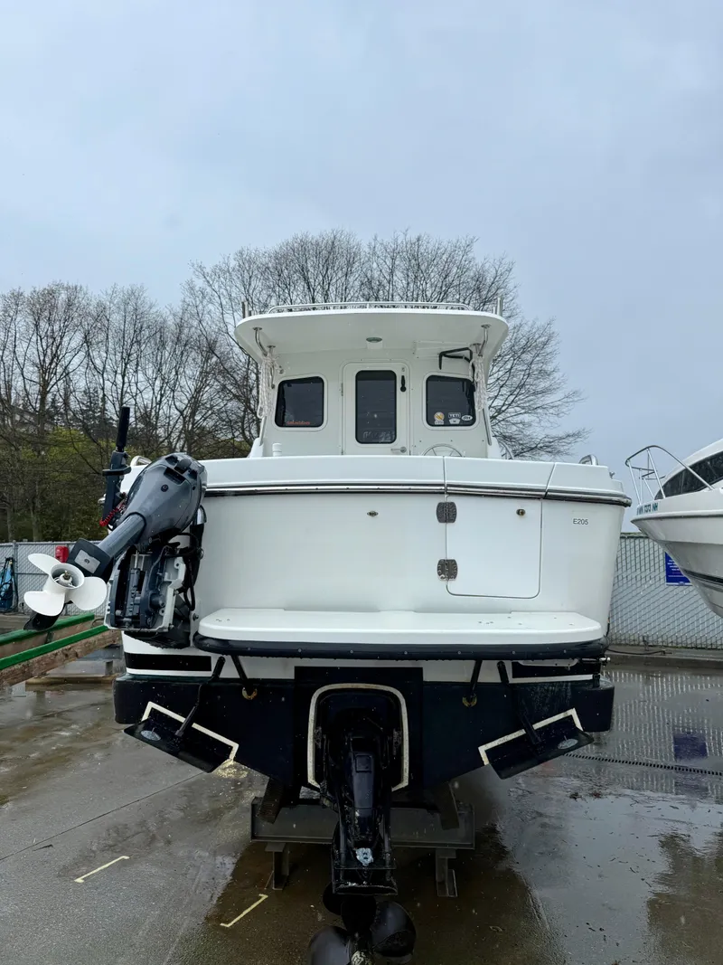 Slide: The Image of 2014 Ocean Sport Legacy #4 boat on trailer, rear view, overcast day. - 3