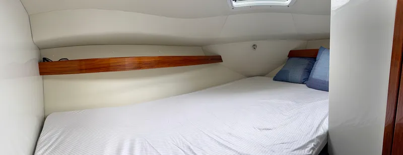 Slide: The Image of Cozy cabin interior of 2014 Ocean Sport Legacy #4 with bed and wooden accents. - 8