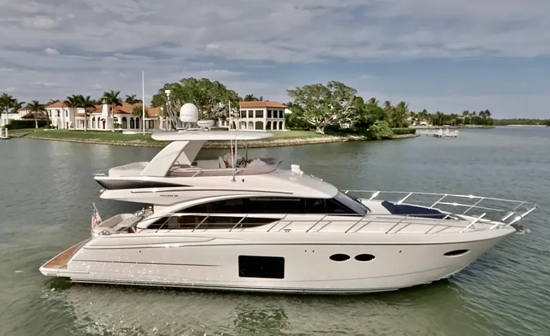 The Image of Luxury 2015 Princess F56 yacht cruising near waterfront homes. - 0