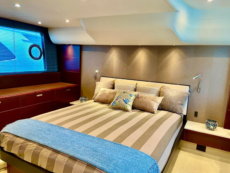 Slide: The Image of Luxurious bedroom interior of 2015 Princess f56 yacht with striped bedding and modern lighting. - 14